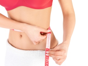 Healthcare and fitness - young fitness female keeping her diet.